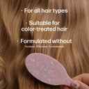 Pink hairbrush with 'UNOVA' branding held against wavy brown hair, with text about product suitability.