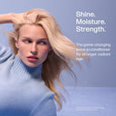 Woman with blonde hair against a light blue background with text about a leave-in conditioner.