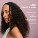 Woman with curly hair on a pink background with text about hair care benefits.