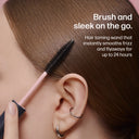 Person using a hair taming wand on their hair with text highlighting its features.