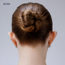 Back view of a person with styled hair bun on a plain background
